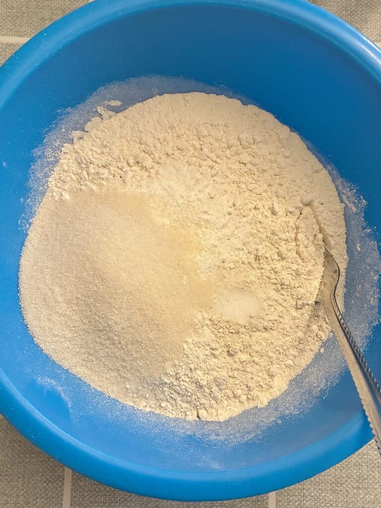 Mixing bowl with oat flour, all-purpose flour, and other baking ingredients for the low-sugar muffin base.
