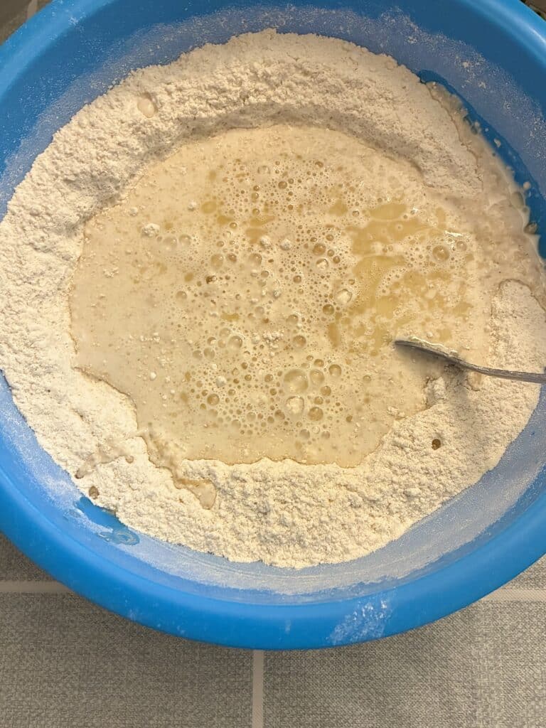 Adding milk and organic avocado oil to dry ingredients for a one-bowl egg-free batter.