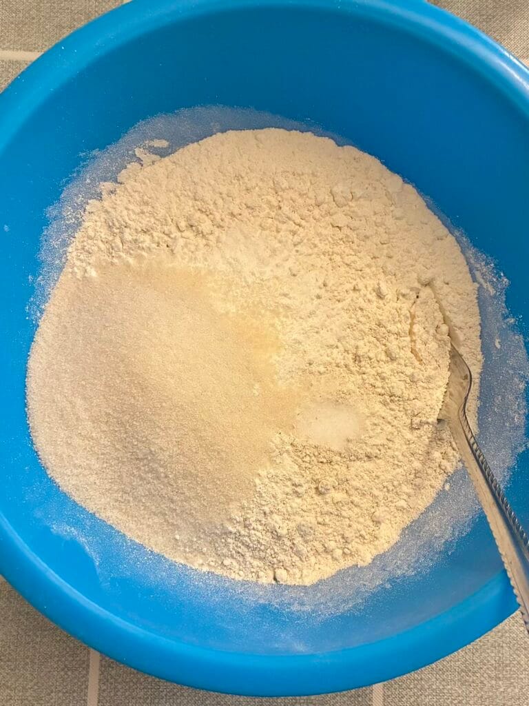 Eggless Oat Flour Chocolate Chip Muffins (No Vinegar) 2 Mixing bowl with oat flour, all-purpose flour, and other baking ingredients for the low-sugar muffin base.