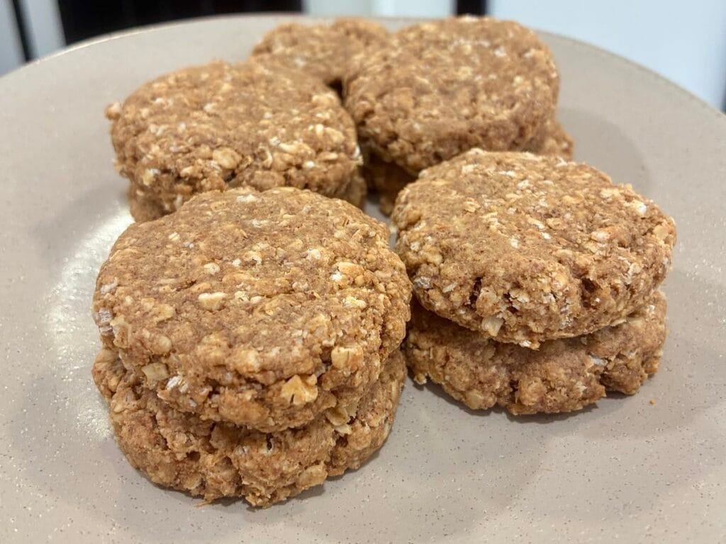 43 Easy Healthy Dessert Recipes 43 A horizontal landscape shot of fresh soft-baked eggless apple oatmeal cookies neatly stacked in rows on a serving plate.