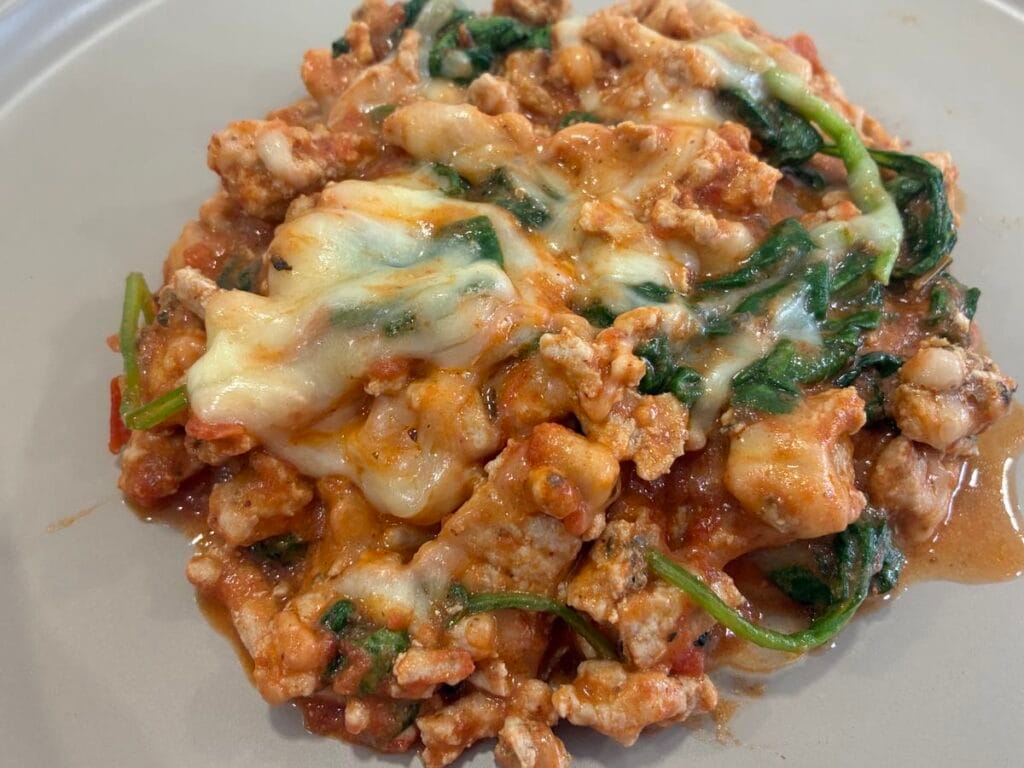 Top down view of a high protein turkey skillet melt served on a plate.