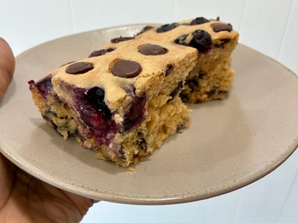 close-up view of a slice of a blueberry chocolate chip cake