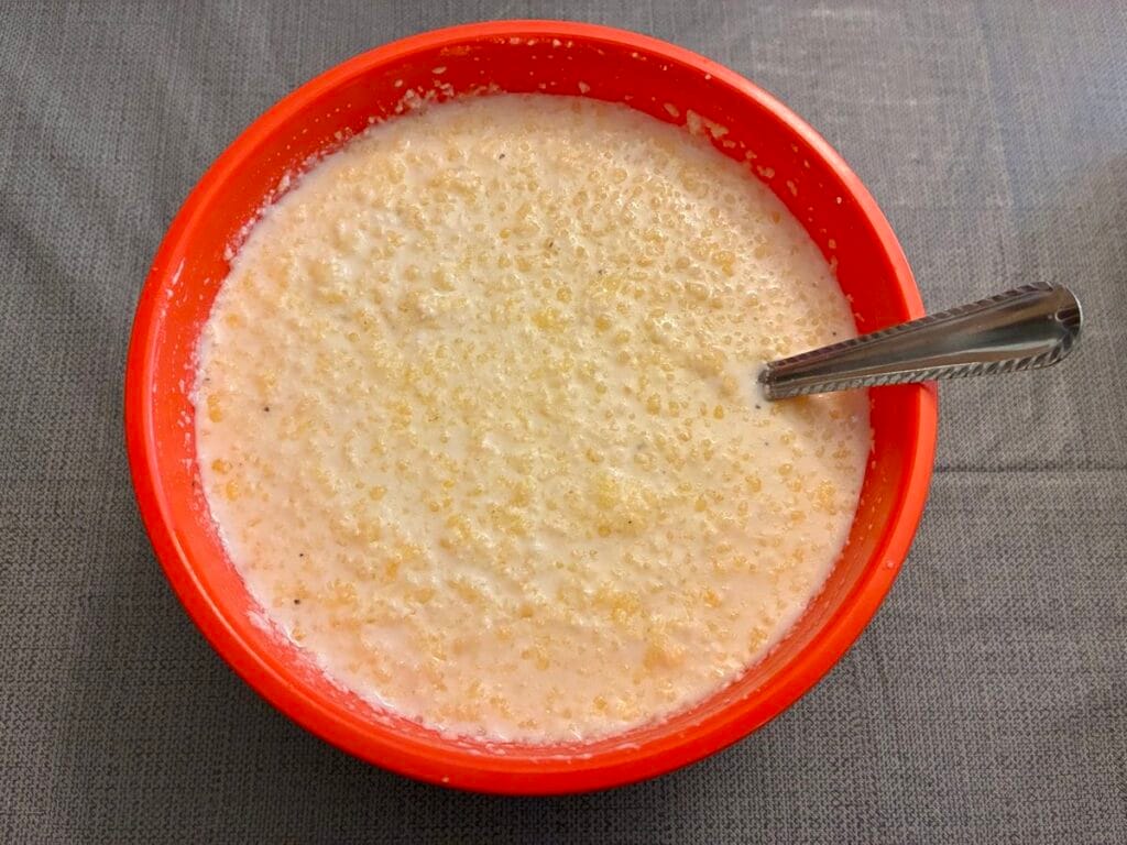 Chicken Alfredo pasta bake liquid ingredients in a mixing bowl
