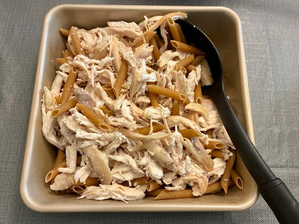 shredded rotisserie chicken and whole wheat penne pasta tossed together in an 8x8 inch square baking pan