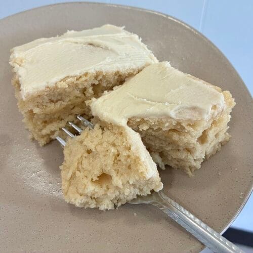 Easy One-Bowl Eggless Vanilla Almond Cake (8x8 Snack Cake) 5 Square slices of moist vanilla almond snack cake cut cleanly and staggered on a dessert plate to showcase the soft interior crumb structure.