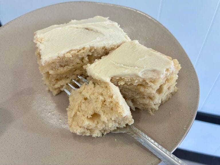 Easy One-Bowl Eggless Vanilla Almond Cake (8x8 Snack Cake) 1 Square slices of moist vanilla almond snack cake cut cleanly and staggered on a dessert plate to showcase the soft interior crumb structure.