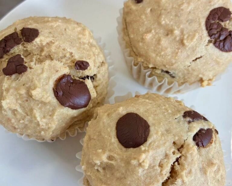 Fluffy healthy oat flour chocolate chip muffins served on a clean white plate