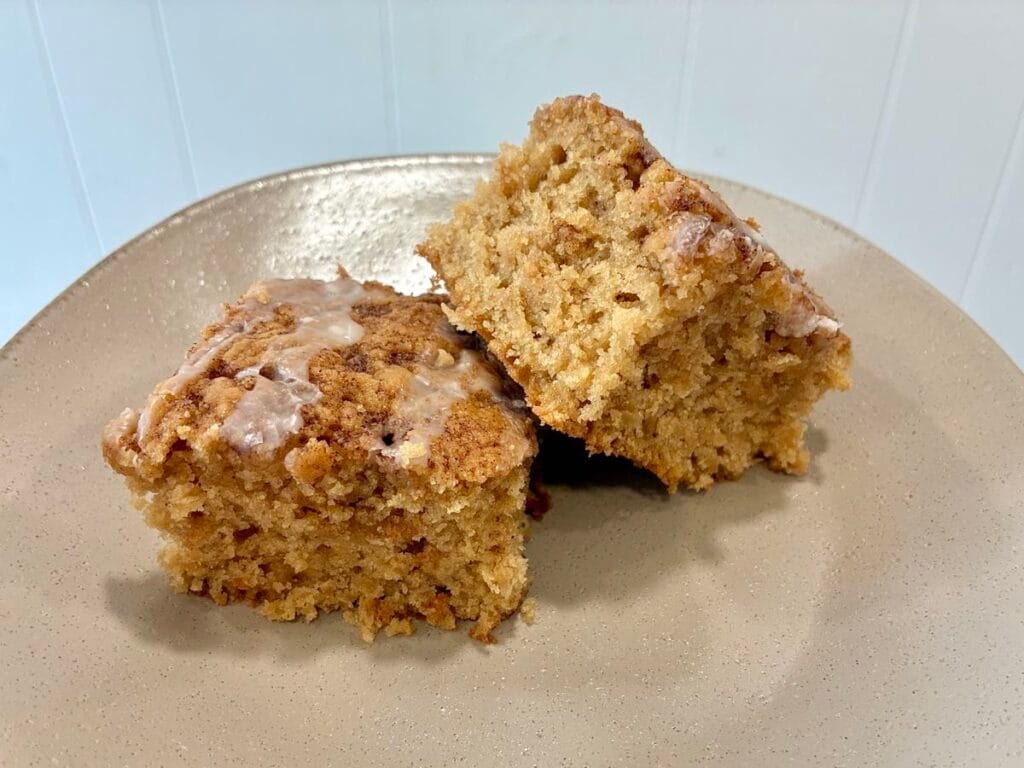 One-Bowl Cinnamon Swirl Snack Cake (Egg-Free Recipe) 2 Two thick, moist square slices of eggless cinnamon swirl snack cake served together on a clean dessert plate.